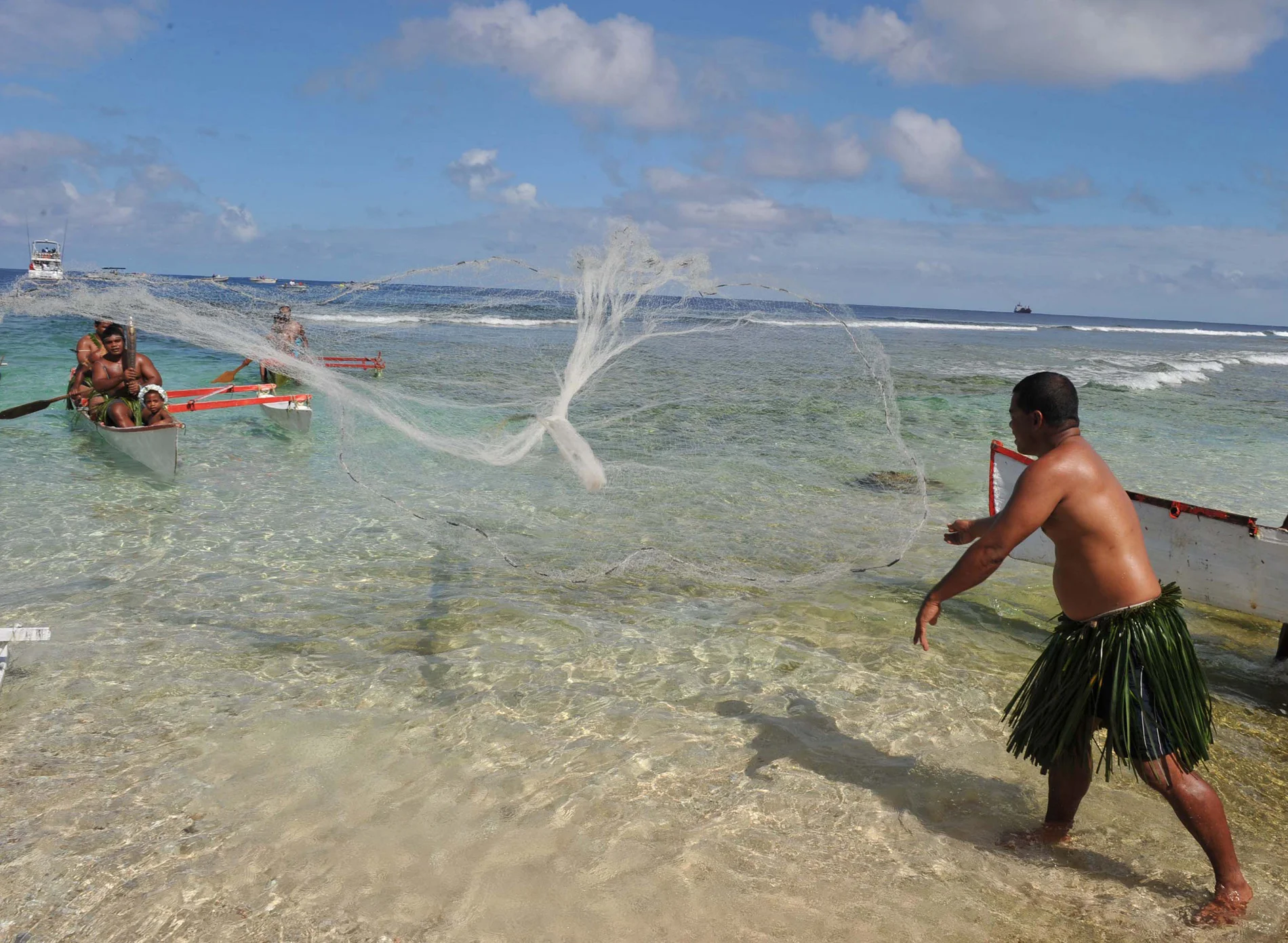 Antony Hiram, a net fisherman throwing a net to catch the Queen's Baton 2010 Delhi on its arrival to the Gabab Channel shore at Nauru on May 8, 2010.